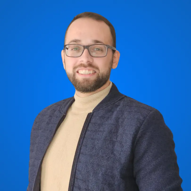 Adrian Peh - Strategic web design and SEO specialist. The founder of thenurtur and designer of this website. Adrian is wearing a blue jacket, light blue turtle-neck blouse has light beard and blue glasses.